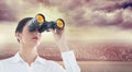 Composite image of business woman looking through binoculars Royalty Free Stock Photo