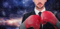 Composite image of businessman with boxing gloves Royalty Free Stock Photo