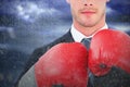 Composite image of businessman with boxing gloves Royalty Free Stock Photo