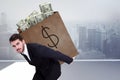 Composite image of businessman carrying bag of dollars Royalty Free Stock Photo