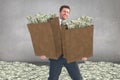 Composite image of businessman carrying bag of dollars Royalty Free Stock Photo