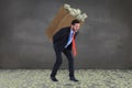 Composite image of businessman carrying bag of dollars Royalty Free Stock Photo