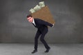 Composite image of businessman carrying something with his back and hands Royalty Free Stock Photo