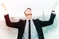 Composite image of businessman cheering with hands raised Royalty Free Stock Photo