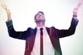 Composite image of businessman cheering with hands raised Royalty Free Stock Photo