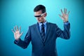 Composite image of businessman imagining while using virtual reality glasses