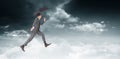 Composite image of businessman jumping holding an umbrella Royalty Free Stock Photo