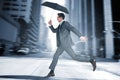 Composite image of businessman jumping holding an umbrella Royalty Free Stock Photo