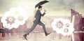 Composite image of businessman jumping holding an umbrella Royalty Free Stock Photo