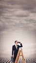 Composite image of businessman looking on a ladder Royalty Free Stock Photo