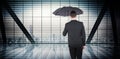 Composite image of businessman sheltering under black umbrella Royalty Free Stock Photo