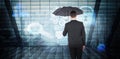 Composite image of businessman sheltering under black umbrella