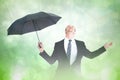 Composite image of businessman sheltering under black umbrella testing Royalty Free Stock Photo