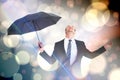 Composite image of businessman sheltering under black umbrella testing Royalty Free Stock Photo