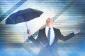 Composite image of businessman sheltering under black umbrella testing Royalty Free Stock Photo