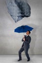 Composite image of businessman sheltering under blue umbrella Royalty Free Stock Photo