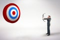 Composite image of businessman shooting a bow and arrow Royalty Free Stock Photo