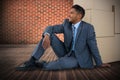 Composite image of businessman sitting near cardboard boxes against white background Royalty Free Stock Photo