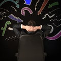 Composite image of businessman sitting in swivel chair Royalty Free Stock Photo