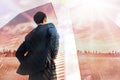 Composite image of businessman standing with hands on hips Royalty Free Stock Photo