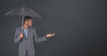 Composite image of businessman standing under umbrella Royalty Free Stock Photo