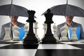 Composite image of businessman standing under umbrella with chessboard Royalty Free Stock Photo