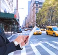 Composite image of businessman in suit using digital tablet Royalty Free Stock Photo