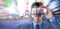 Composite image of businessman in suit using virtual reality headset Royalty Free Stock Photo