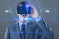 Composite image of businessman in suit using virtual reality headset Royalty Free Stock Photo