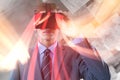 Composite image of businessman in suit using virtual reality headset