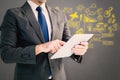 Composite image of businessman using his tablet pc Royalty Free Stock Photo