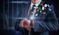 Composite image of businessman using hologram watch