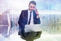Composite image of businessman using laptop while phoning Royalty Free Stock Photo