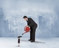 Composite image of businessman watering tiny businesswoman Royalty Free Stock Photo