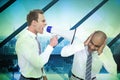 Composite image of businessman yelling with a megaphone at his colleague Royalty Free Stock Photo