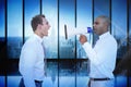 Composite image of businessman yelling with a megaphone at his colleague Royalty Free Stock Photo