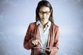 Composite image of businesswoman with eyeglasses using a tablet Royalty Free Stock Photo