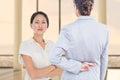 Composite image of businesswoman with fingers crossed behind her back over white background