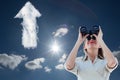Composite image of businesswoman looking through binoculars Royalty Free Stock Photo