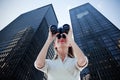 Composite image of businesswoman looking through binoculars Royalty Free Stock Photo