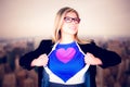 Composite image of businesswoman opening her shirt superhero style