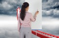 Composite image of businesswoman painting on an easel