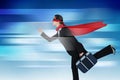 Composite image of businesswoman running while pretending to be super hero Royalty Free Stock Photo