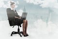 Composite image of businesswoman sitting on swivel chair with laptop