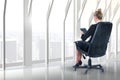 Composite image of businesswoman sitting on swivel chair with tablet