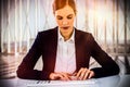 Composite image of businesswoman typing on keyboard at desk Royalty Free Stock Photo