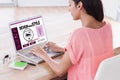 Composite image of businesswoman using laptop at desk in creative office Royalty Free Stock Photo