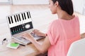 Composite image of businesswoman using laptop at desk in creative office Royalty Free Stock Photo