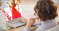 Composite image of businesswoman using laptop at desk in creative office Royalty Free Stock Photo