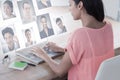 Composite image of businesswoman using laptop at desk in creative office Royalty Free Stock Photo